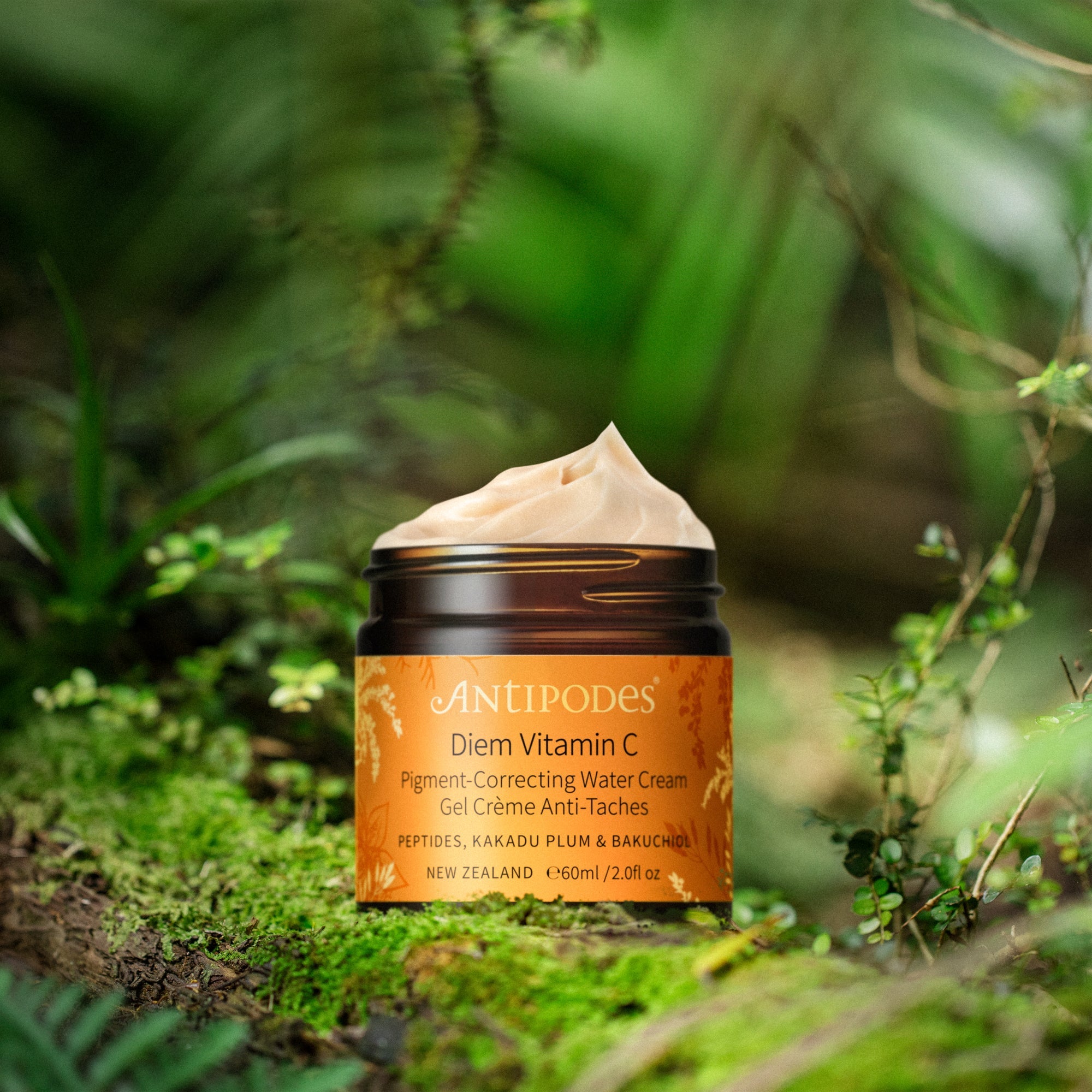 Antipodes Diem Vitamin C cream jar on a natural background with greenery
