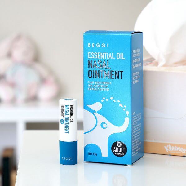 Beggi Essential Oil Nasal Ointment packaging on a surface with a blurred background