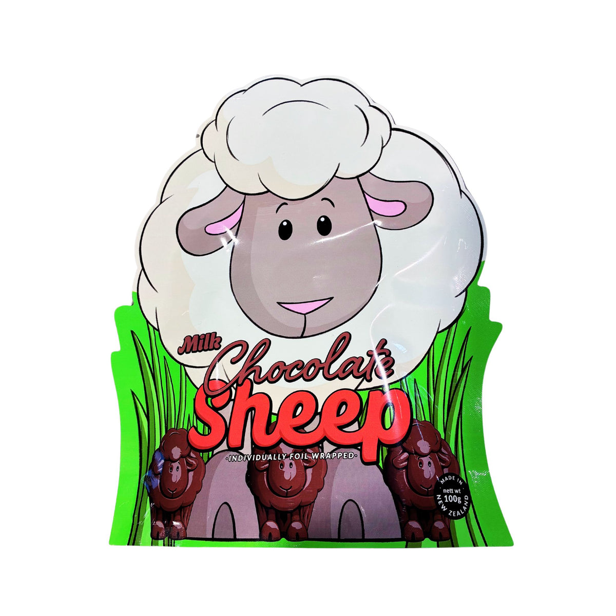 A packaged novelty chocolate bar shaped like a cartoon sheep with white wool, a gray face, pink ears, green grass, and the words 'Milk Chocolate Sheep' on a white background.