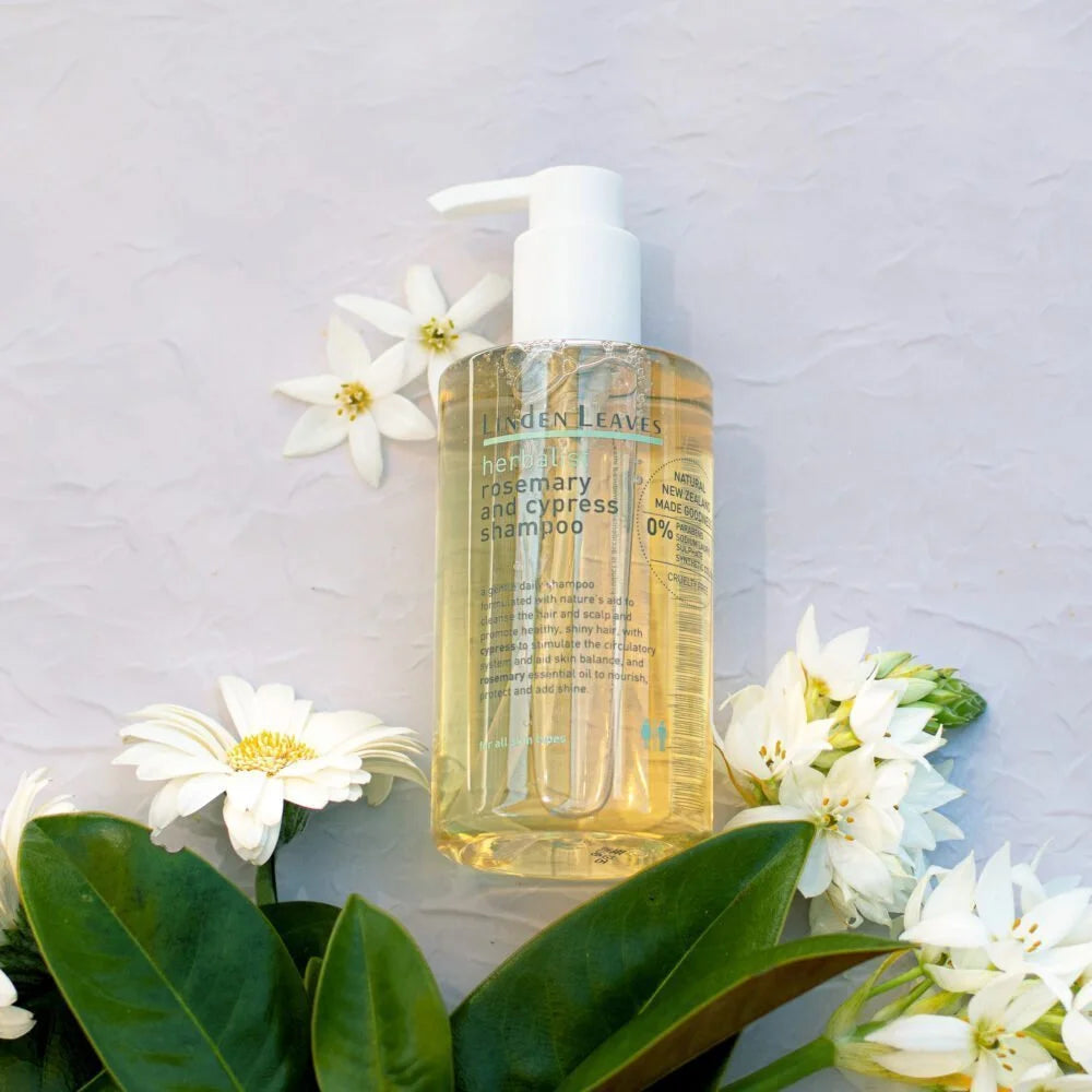 Bottle of Linden Leaves shampoo with flowers and leaves on a light gray background