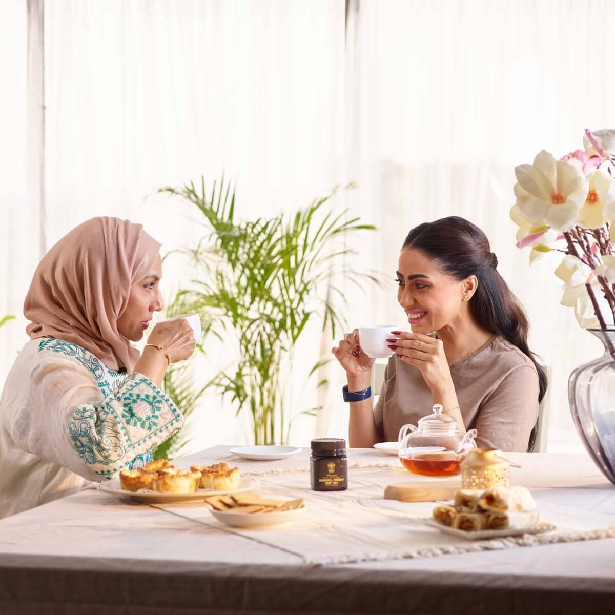 Two ladies haveing tea with Manuka South Manuka Honey