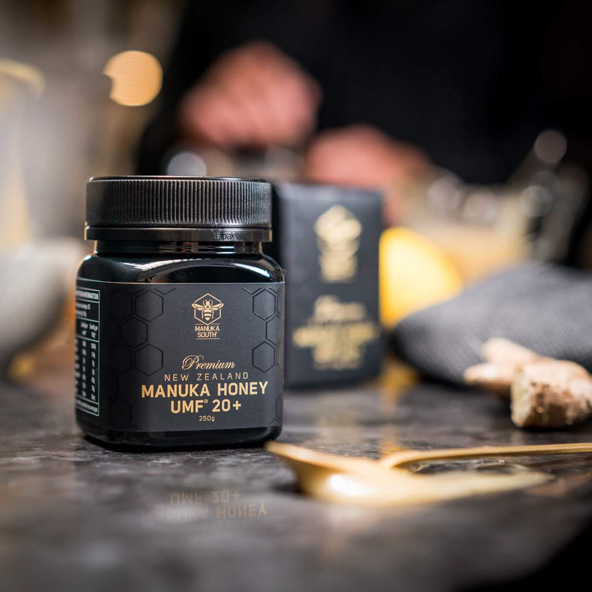 Manuka South Manuka South UMF 20+ 250g jar on black table with spoon