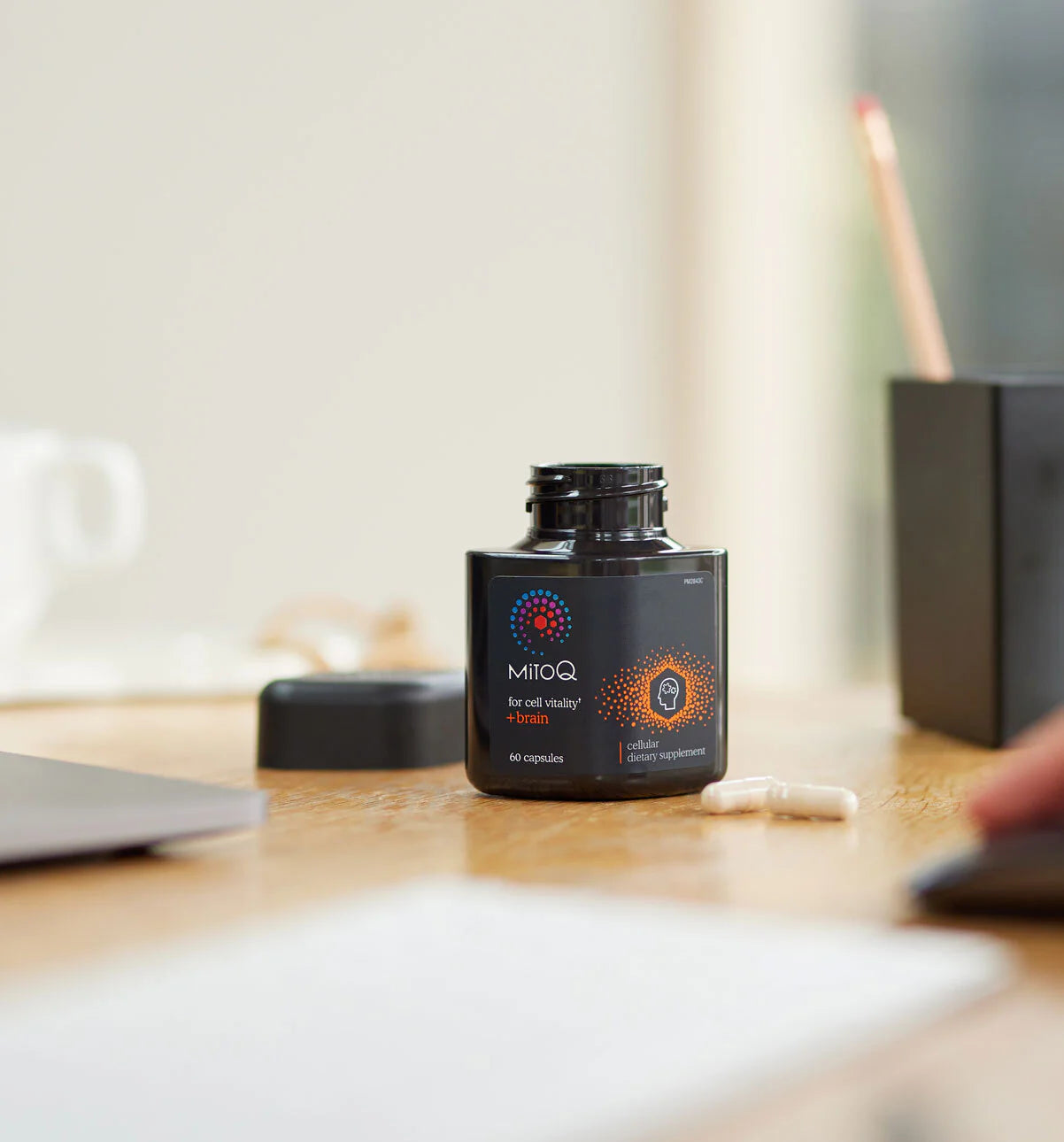 MitoQ Brain bottle on a desk with a blurred background