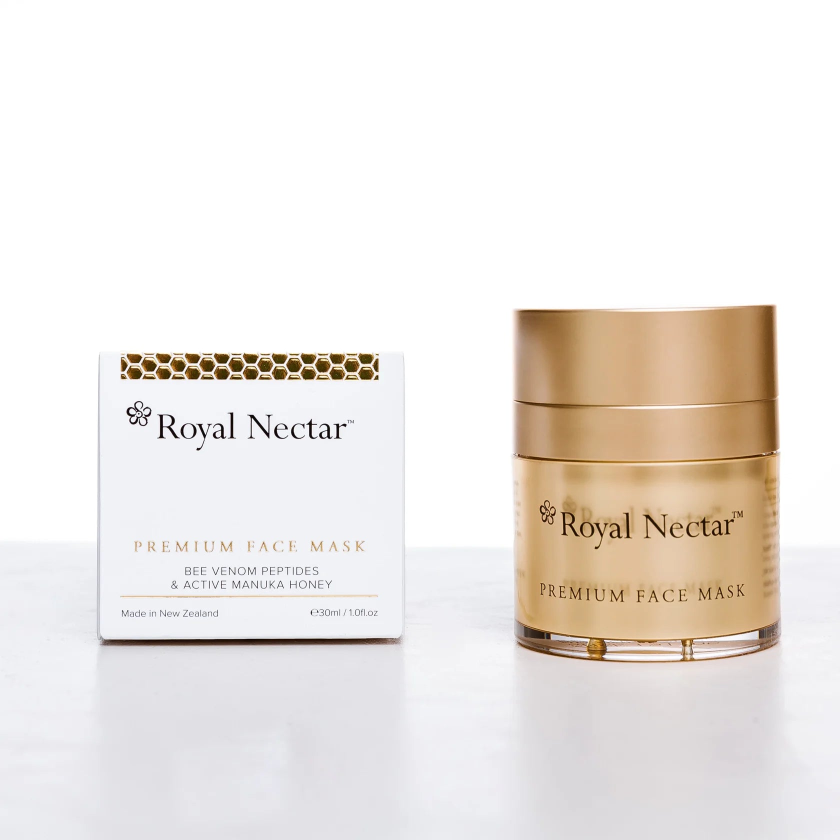 Gold jar and box of Royal Nectar Premium Face Mask on a white background