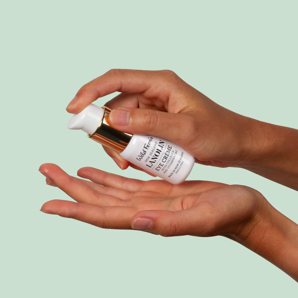 Person holding a wild ferns eye creme with a light green background