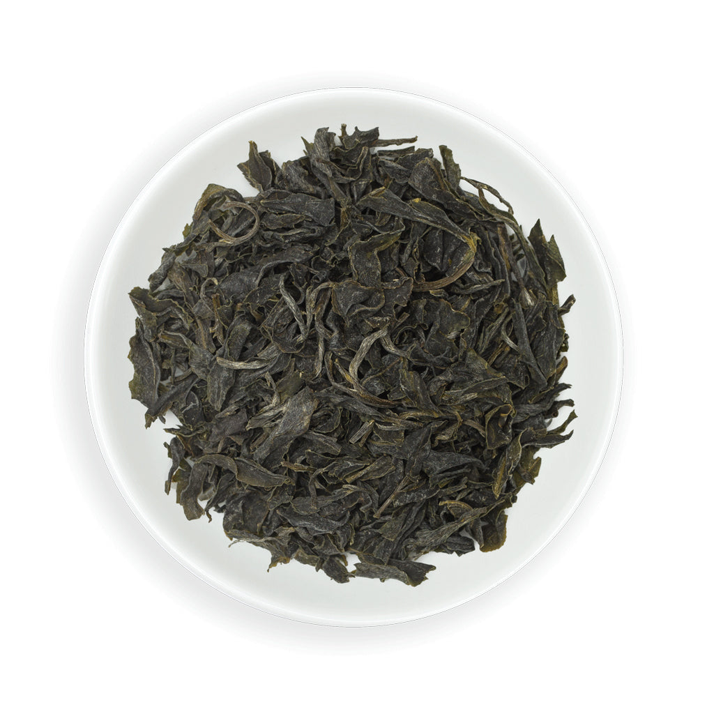 Zealong Tea dry green tea leaves on a white plate