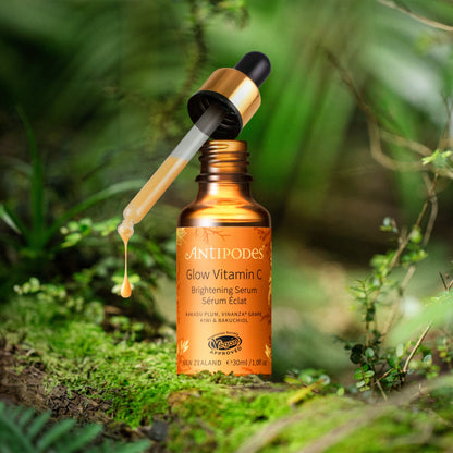 Antipodes Glow Vitamin C serum bottle with dropper on a natural background