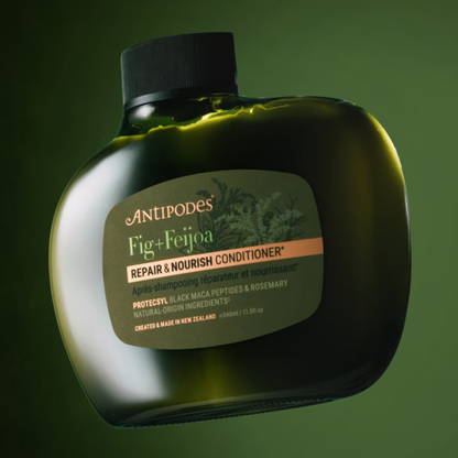 Antipodes Fig & Feijoa Repair & Nourish Conditioner bottle on a green background