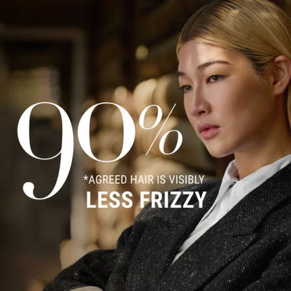 Woman with styled hair and text about hair frizz reduction, blurred background for Antipodes Fig Feijoa Shampoo