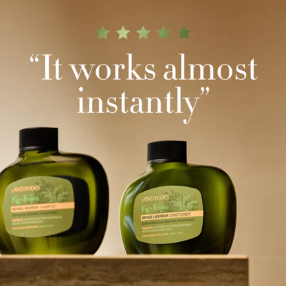 Two green bottles of r Antipodes Fig Feijoa Shampoo and conditioner with black caps on a wooden shelf against a beige background, featuring text 'It works almost instantly'.