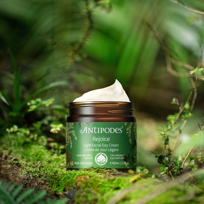 Antipodes Rejoice light facial day cream jar with green label on a natural background