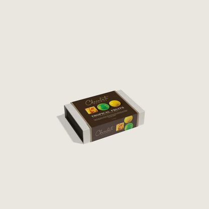 Box of chocolates labeled 'Tropical Fruits' on a light beige background