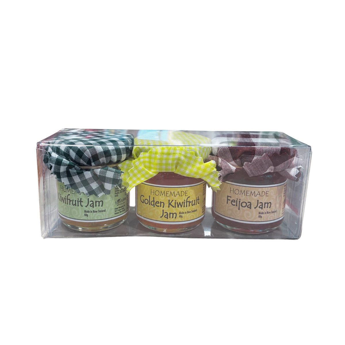 A three-pack of homemade fruit jams in a clear plastic gift box. The jars are labeled Honey Kiwifruit Jam, Homemade Golden Kiwifruit Jam, and Homemade Feijoa Jam, each with a checkered ribbon bow on top.