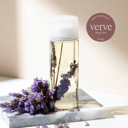 Linden Leaves Body oil Absolute Dreams  bottle with lavender flowers on a marble surface, featuring 'verve' branding.