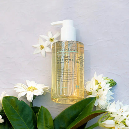 Bottle of Linden Leaves shampoo with flowers and leaves on a light gray background
