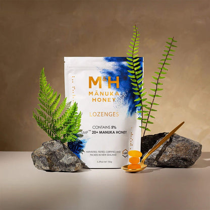 M&H Mánuka Honey lozenges packaging with honeycomb and leaves on a neutral background