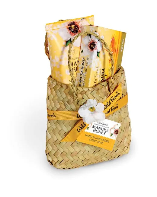 Woven basket with Manuka Honey products on a white background