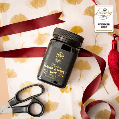 Manuka South Manuka honey UMF10+ 500g jar with decorative elements on a patterned background