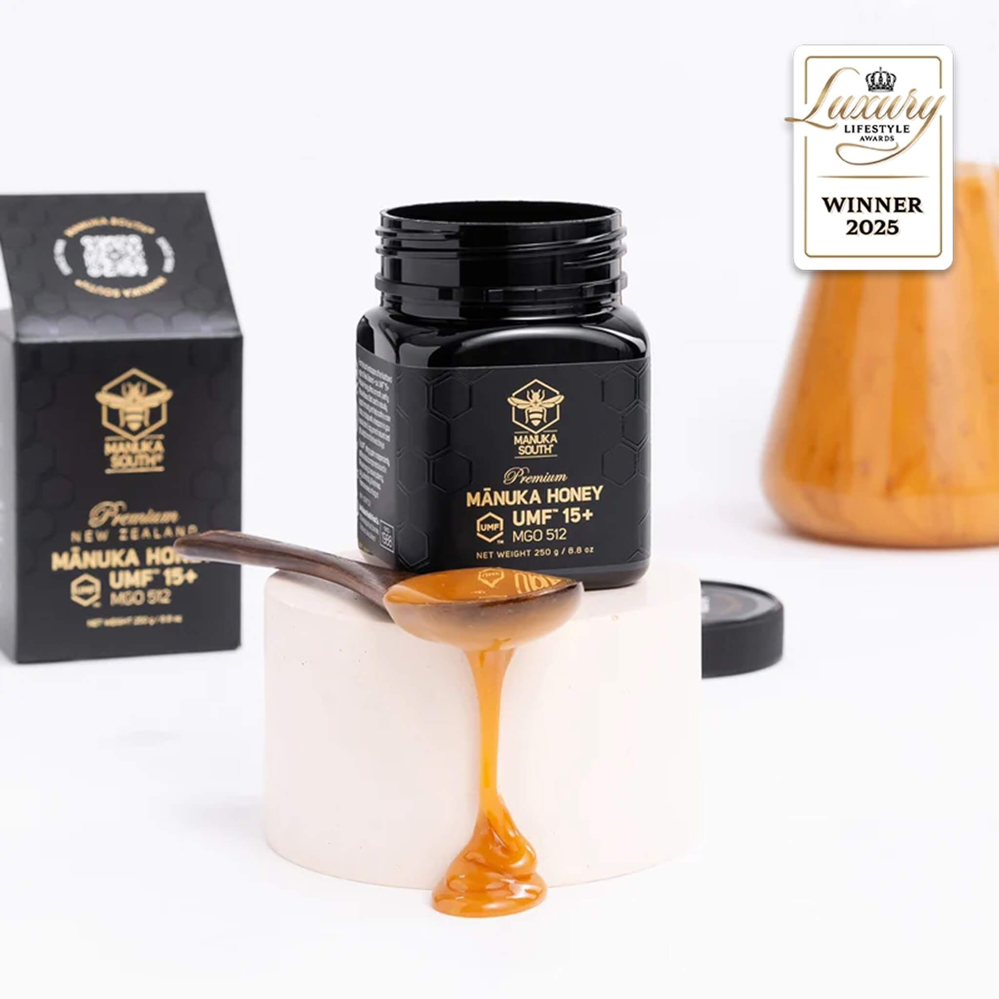 Manuka South Manuka honey UMF 15+ 250g jar with honey on a spoon, packaging, and a 'Winner 2025' badge on a white background