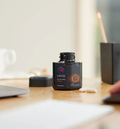 MitoQ Brain bottle on a desk with a blurred background