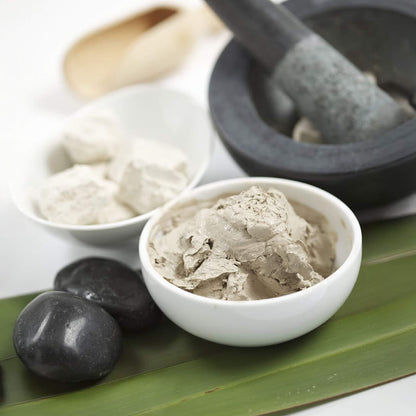Two bowls of Puresource Rotorua Thurmal Mud Mask  with a pestle and mortar on a white background