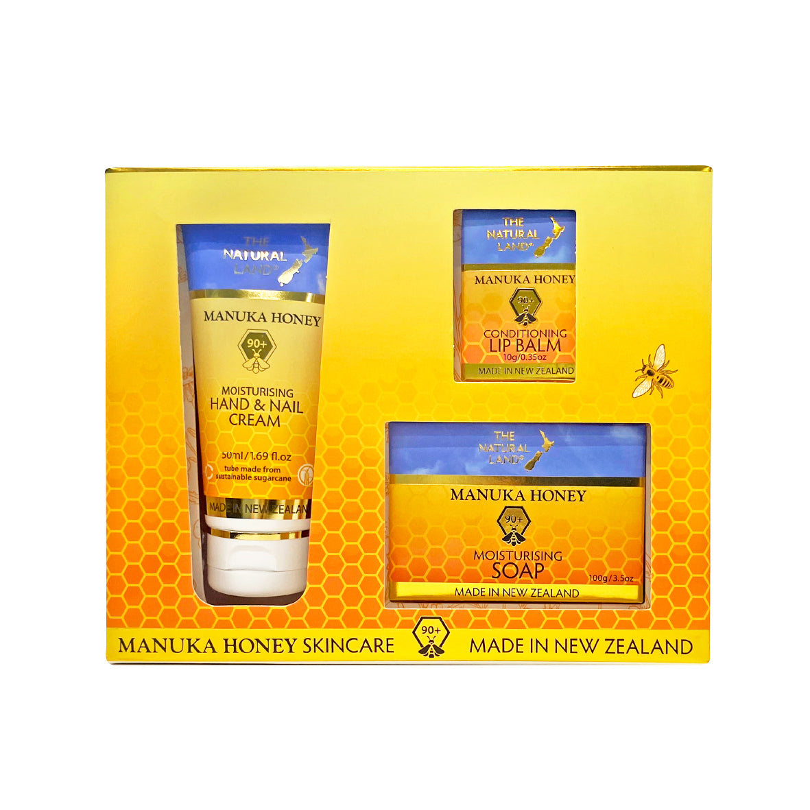 The Natural Land Manuka Honey skincare set with cream, soap, and lip balm in a yellow box.