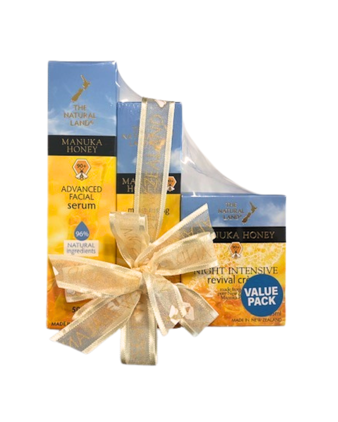 The Natural Land gift set of Manuka honey skincare products, including a recovery eye cream, advanced facial serum, and night intensive cream, packaged in a box tied with a ribbon.