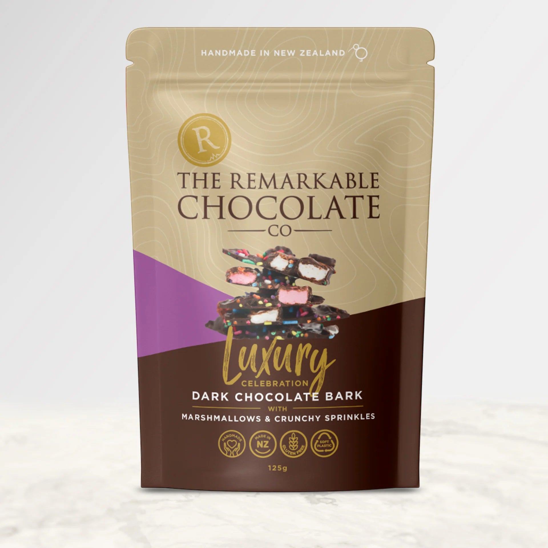 Packaging of The Remarkable Chocolate Co. featuring dark chocolate bark with marshmallows and sprinkles.