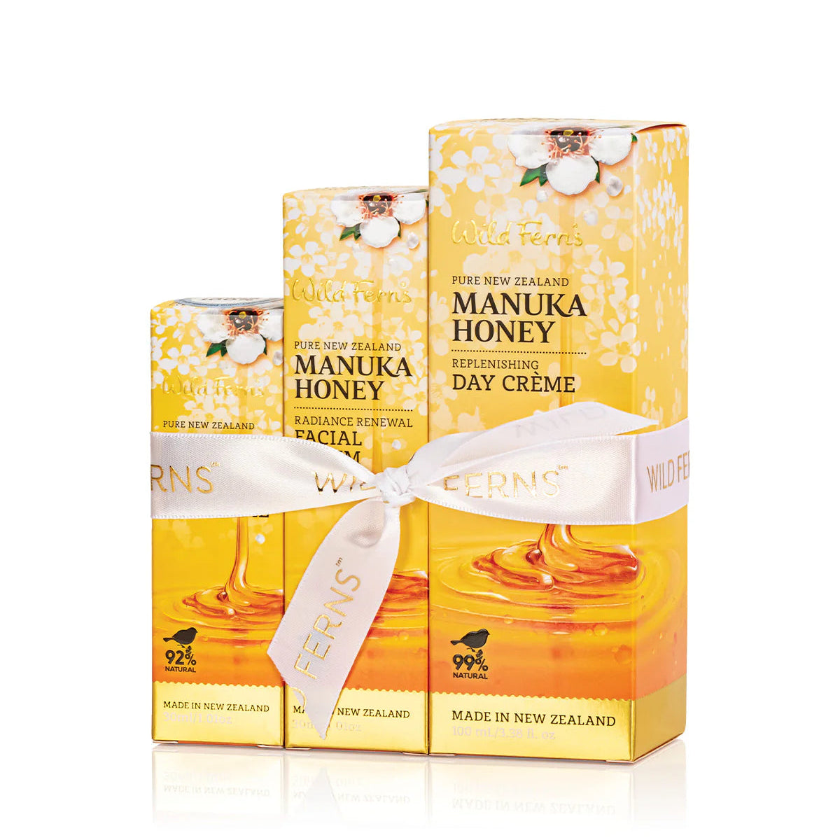 Three boxes of Wild Ferns Manuka Honey Srerum and Creme Set on a white background